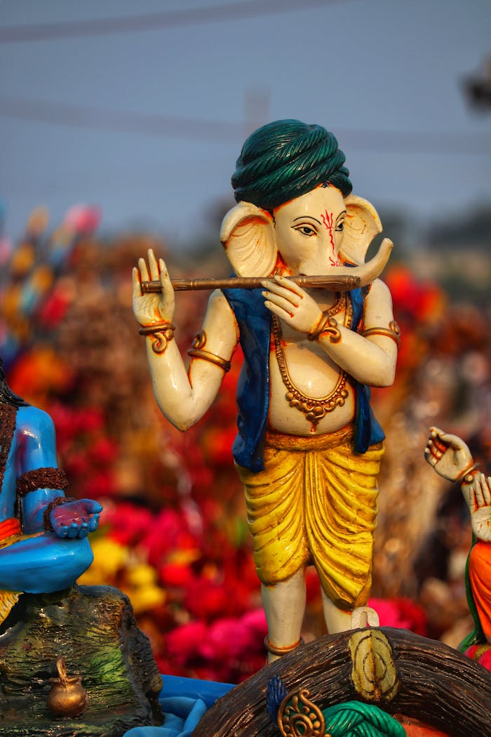 Close-up of a vibrant Ganesh figurine playing a flute, symbolizing Hindu spirituality.