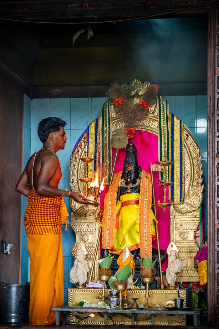 An adult male performs a vibrant Hindu ritual in a Vavuniya temple, Northern Sri Lanka.